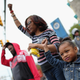 A young girl raises her fist along with others after Baltimore authorities released a report on the death of Freddie Gray on May 1, 2015, in Baltimore. (Win McNamee/Getty Images)